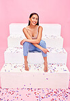 Woman smile, confetti and steps portrait with style and fashion with celebration sparkle. Studio, pink background and female model with party, event and birthday decoration with gen z confidence