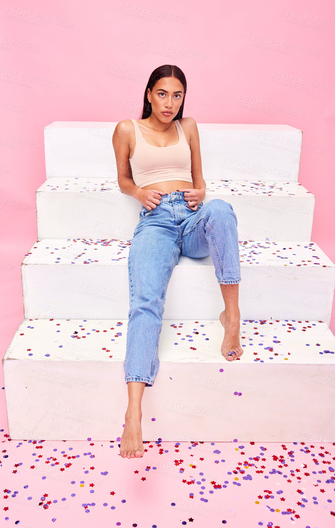 Buy stock photo Woman, confetti and sitting on steps portrait with relax, style and fashion with celebration sparkle. Studio, pink background and model with party, event and birthday decoration with confidence