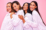 Women, friends hug and portrait in studio with natural beauty, diversity and white shirt with laugh. Pink background, bonding and young female group together with inclusion, happy smile and wellness