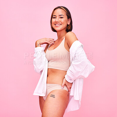 Buy stock photo Asian woman, underwear and smile in studio portrait, shirt and beauty with healthy body by pink background. Japanese fashion model, girl and lingerie with confidence, body positive and cosmetics