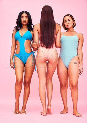 Buy stock photo Body positivity, bikini and group of women in studio, standing together in solidarity or diversity. Portrait of beauty, summer fashion and swimwear models with self love, equality and pink background
