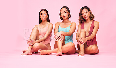 Buy stock photo Portrait, studio and group of women in bikini sitting together with diversity, solidarity and body positivity. Beauty, summer fashion and swimwear models with self love, equality and pink background.