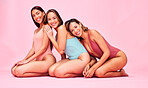 Diversity, bikini and portrait of friends in studio, sitting together with smile or fun body positivity. Beauty, summer fashion and happy women in swimwear for self love, equality and pink background