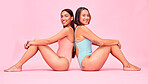 Diversity, bikini and women in studio, sitting together with smile and fun body positivity portrait. Beauty, summer fashion and happy swimwear models with self love, equality and pink background.