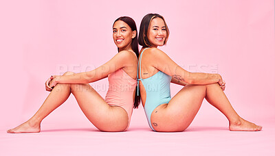 Buy stock photo Diversity, swimwear and women in studio portrait, sitting together with smile and fun body positivity. Beauty, summer fashion and happy bikini models with self love, equality and pink background.