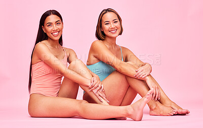 Buy stock photo Diversity, swimwear and portrait of women in studio, sitting together with smile and fun body positivity. Beauty, summer fashion and happy bikini models with self love, equality and pink background.