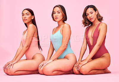 Buy stock photo Beauty, body and portrait of group of women in studio, sitting together with diversity and bikini. Underwear, summer fashion aesthetic and swimwear models with self love, equality and pink background