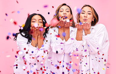 Buy stock photo Blowing confetti, friends and women in studio for party celebration, fashion sale and discount. Bonding, diversity and happy people on pink background for support, natural beauty and retail promotion