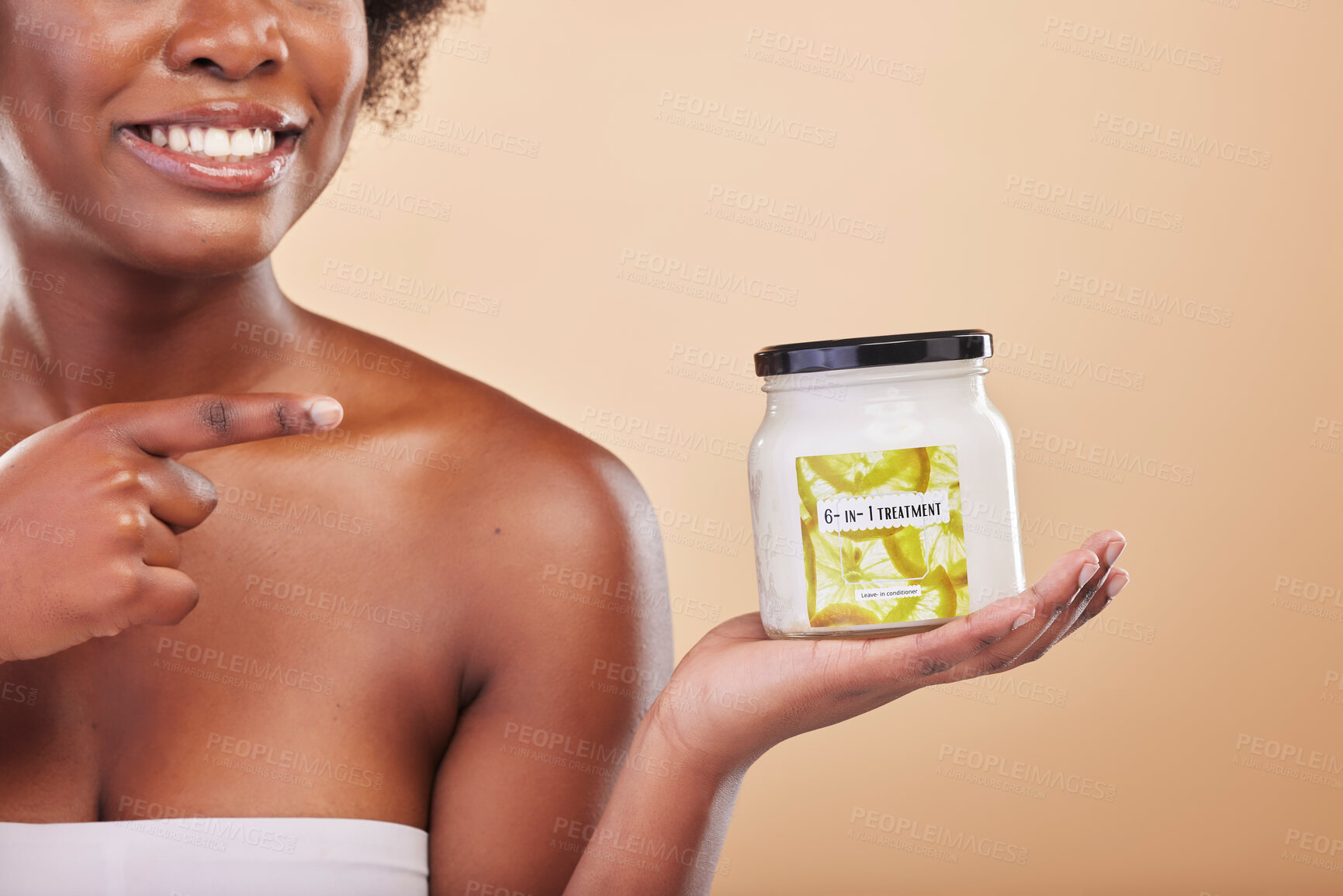 Buy stock photo Hand, pointing and product for beauty, treatment or antiaging with a woman in studio on beige background. Skincare, container and advertising or marketing a lotion for aesthetic wellness or body care