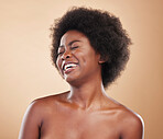 Black woman, laughing face and beauty in studio with skin care, dermatology and natural glow. Happy and funny African model person with afro hair, cosmetics and self love on a beige background