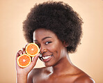 Orange skincare, portrait and woman on studio background for natural cosmetics, healthy benefits and nutrition. Happy african beauty model with citrus fruits for vitamin c, detox and eco dermatology