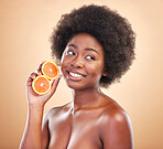 Orange, natural skincare and woman on studio background for healthy cosmetics, vegan benefits or nutrition. Happy african beauty model thinking of citrus fruits for vitamin c, diet or eco dermatology