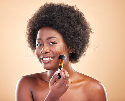 Buy stock photo Portrait, beauty and a black woman with a makeup brush for blush to apply cosmetics to her face. Smile, aesthetic and afro with a happy young model using a product on her skin to enhance appearance