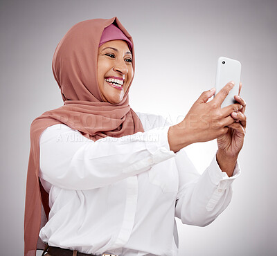 Buy stock photo Woman, muslim selfie and happy in studio for social media, influencer blog with fashion and hijab. Islamic person from Saudi Arabia in profile picture photography and clothes on a  white background