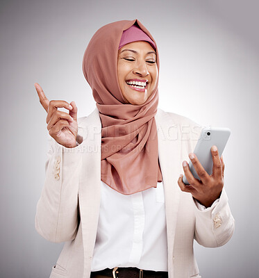 Buy stock photo Phone, social media and a senior muslim woman in studio on a gray background for communication as an app user. Mobile, finger print or biometrics with a happy islamic person browsing the internet