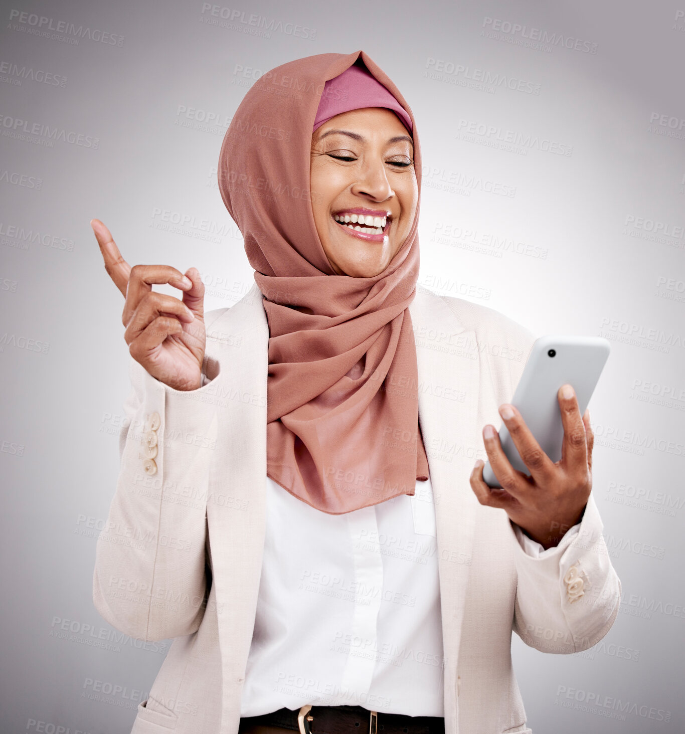 Buy stock photo Phone, social media and a senior muslim woman in studio on a gray background for communication as an app user. Mobile, finger print or biometrics with a happy islamic person browsing the internet