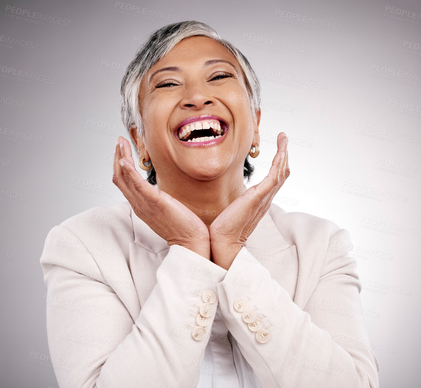 Buy stock photo Funny, portrait and beauty of mature woman in suit in studio isolated on a white background. Face hands, makeup cosmetics and excited model with laugh in spa facial treatment for skincare antiaging