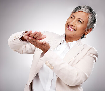 Smile, money gesture and senior woman in a studio with cashback, prize or financial freedom. Happy, excited and elderly female model with finance hand sign or emoji for savings by a gray background.