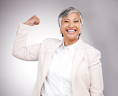 Strong, smile and portrait of businesswoman in a studio with strength or confidence gesture. Happy, excited and mature female model from Mexico flexing her arm muscles for emoji by a gray background.