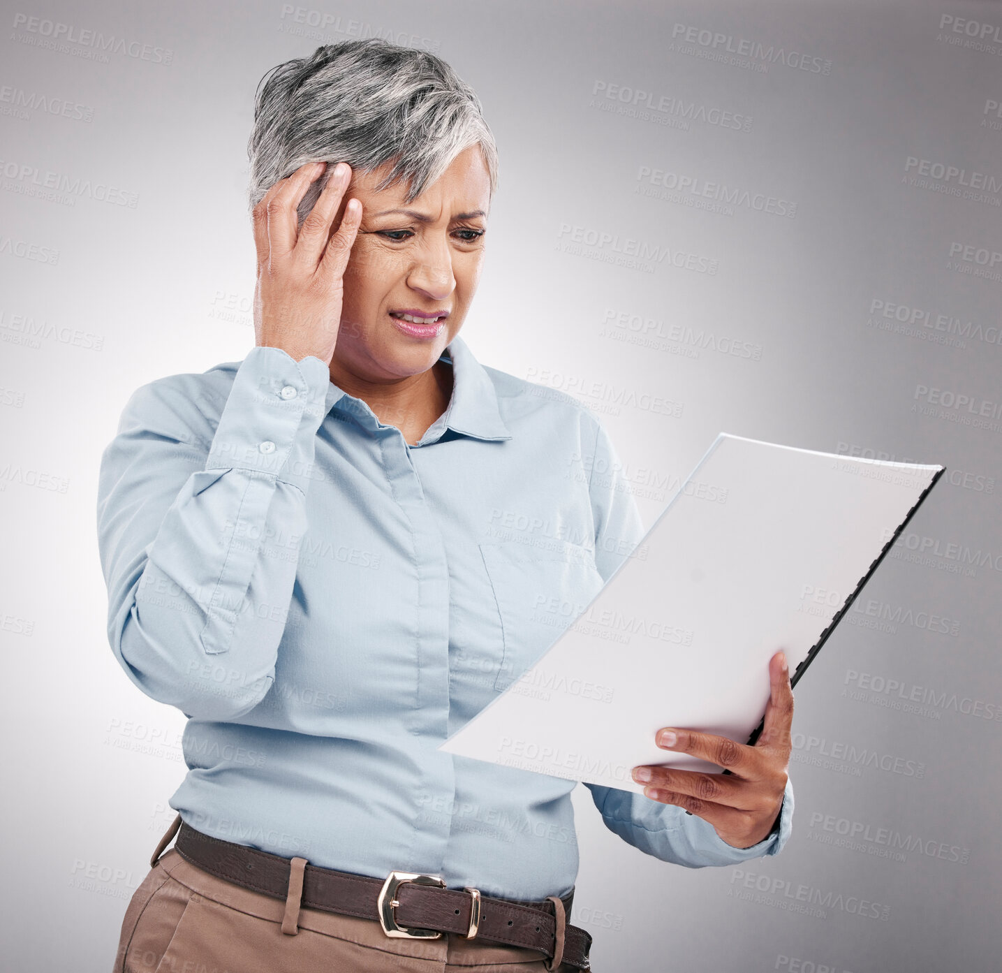 Buy stock photo Problem, mature and a woman with a report on a studio background for planning of business with stress. Headache, corporate and a manager or employee reading a document with a mistake or frustrated