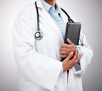 Buy stock photo Tablet, technology and hands of doctor in studio for healthcare services, telehealth support and help. Closeup of medical worker, digital connection and consulting clinic research on gray background