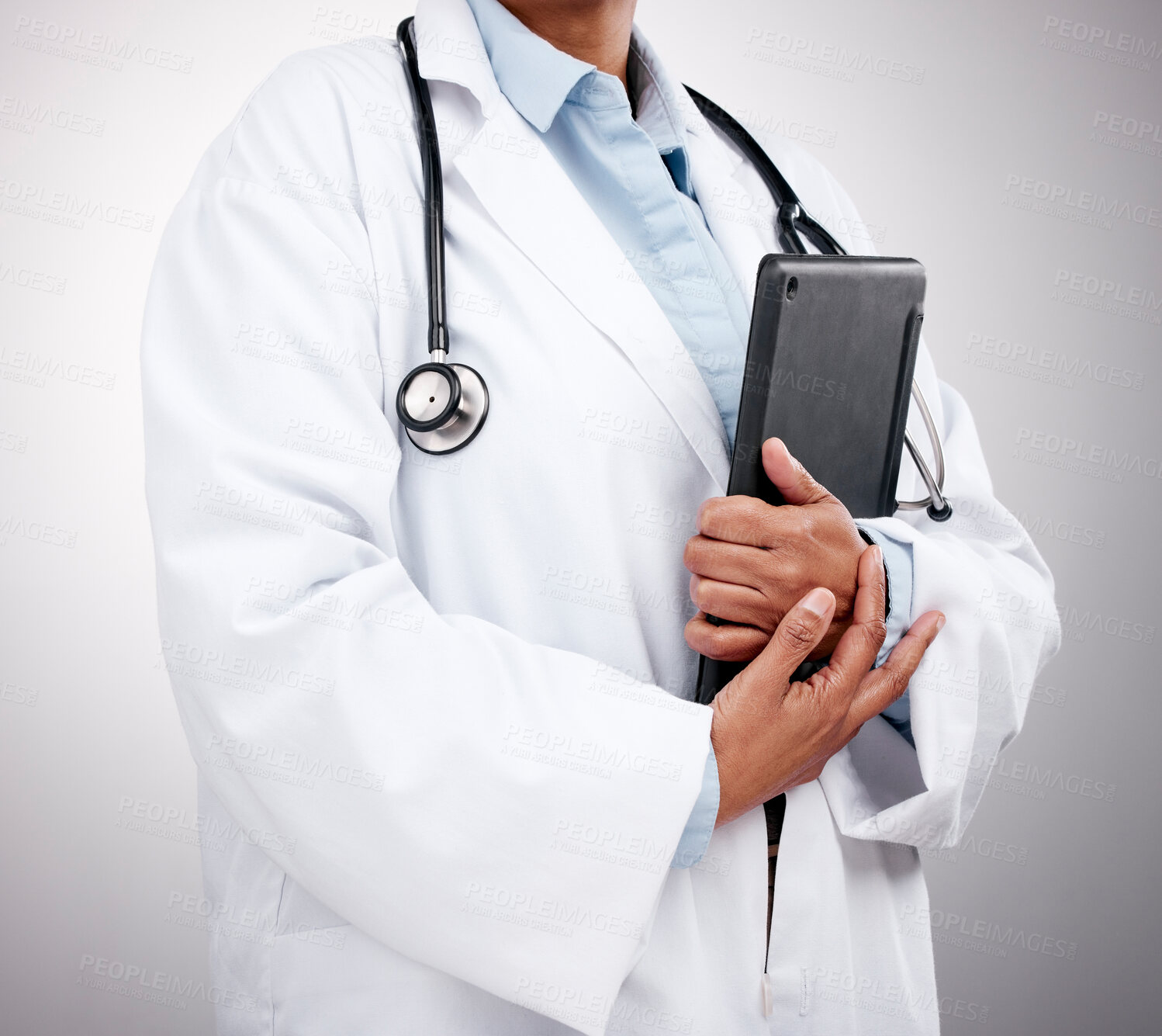 Buy stock photo Tablet, technology and hands of doctor in studio for healthcare services, telehealth support and help. Closeup of medical worker, digital connection and consulting clinic research on gray background