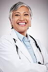Woman, portrait and doctor with arms crossed in studio for healthcare services, smile and consulting. Happy mature surgeon, expert therapist and medical professional with trust on gray background 