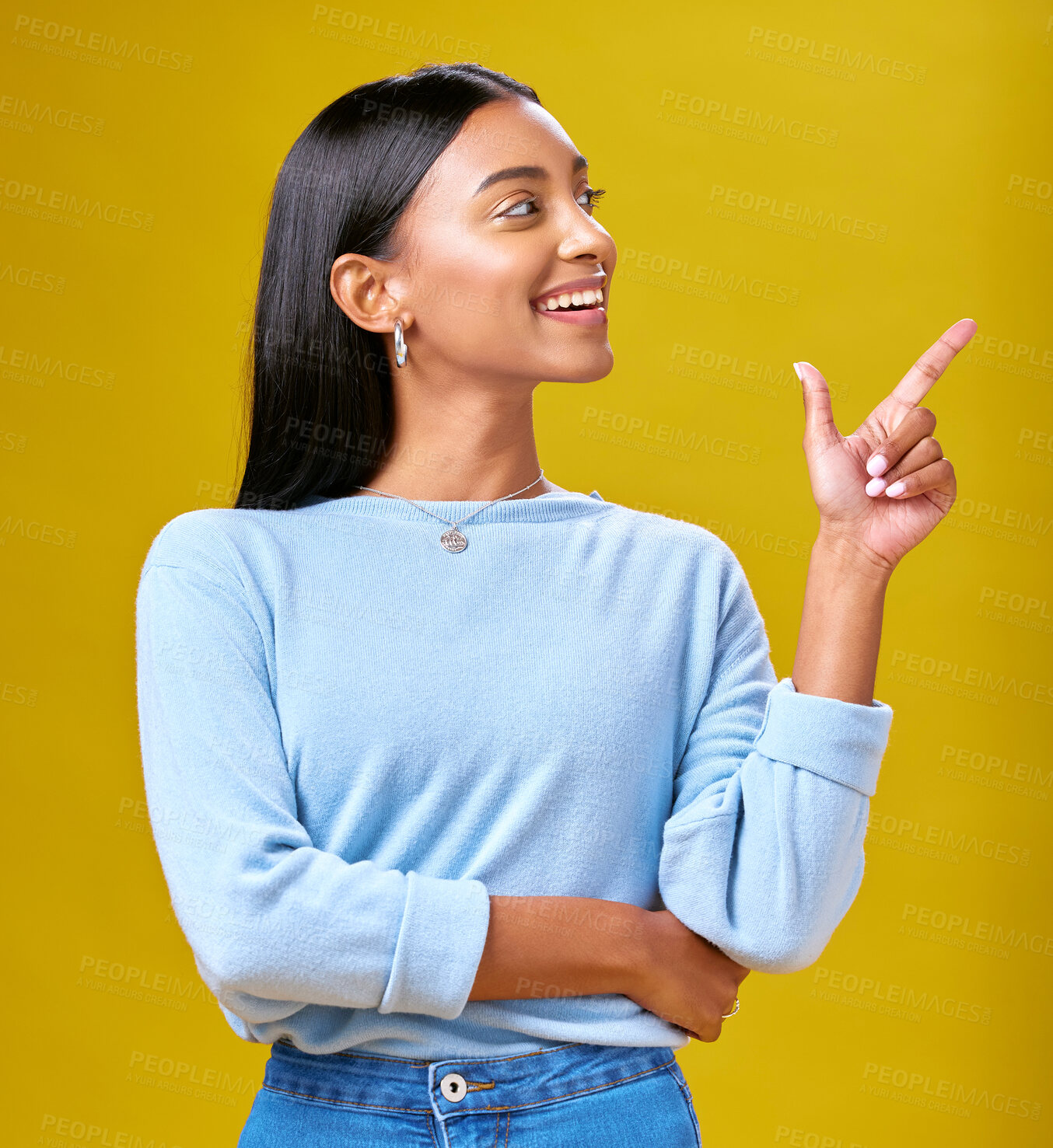 Buy stock photo Pointing, smile and young woman in a studio for advertising, marketing or promotion. Happy, excited and Indian female model with a direction or arrow hand gesture isolated by yellow background.