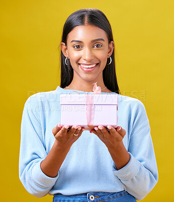 Buy stock photo Woman, winner portrait and gift box, offer and prize for giveaway or shopping on yellow background. Happy person with present and ribbon package for retail sale, winning or competition in studio