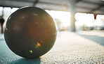 Gymnastics ball on floor for sports, fitness and lens flare with mockup for exercise, performance or rhythmic dance. Light, ground and aerobics equipment in gym, arena or workout space with sunshine.