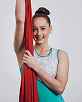Portrait, ribbon dancer and performance with a woman in studio on a gray background for routine training. Fitness, smile and energy with a happy athlete holding fabric for a competition showcase