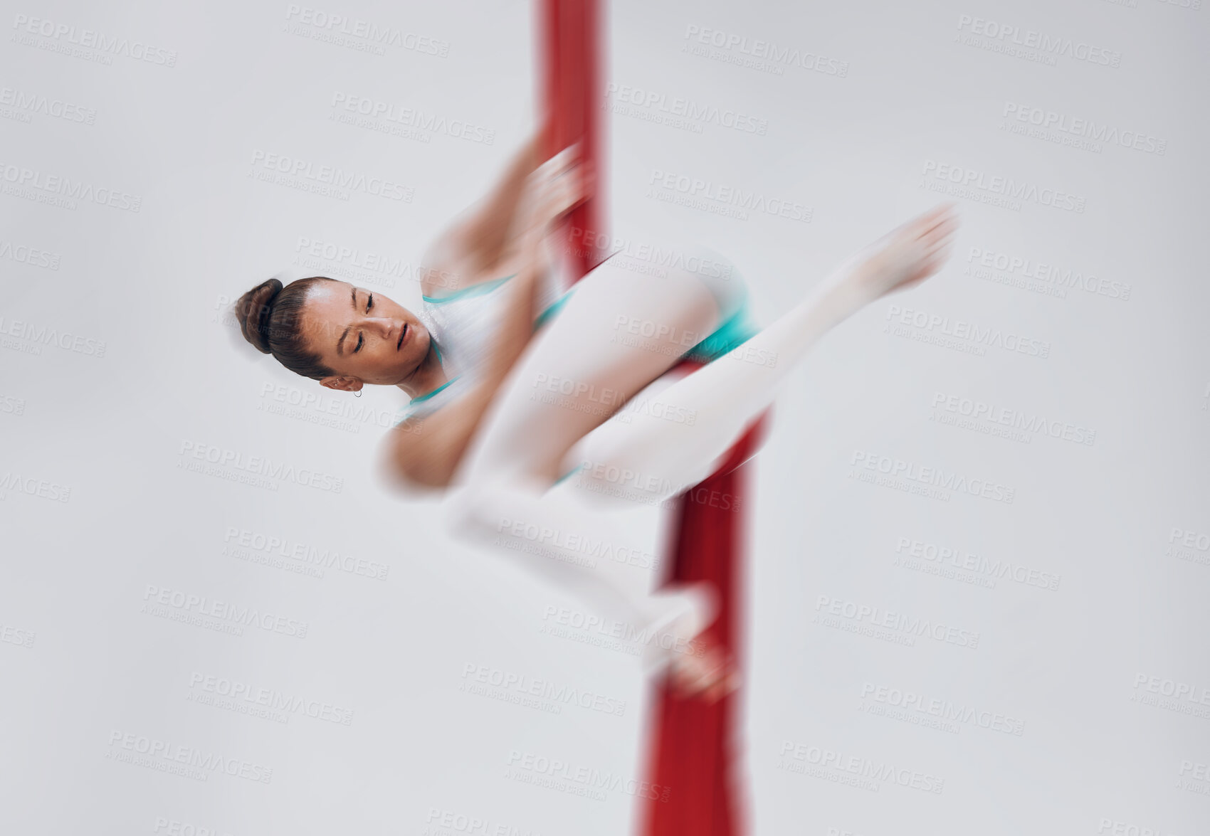 Buy stock photo Gymnastics, woman and aerial silk with a acrobat in air for performance, sports and balance. Young athlete person or gymnast hanging on red fabric and white background with space, art and creativity