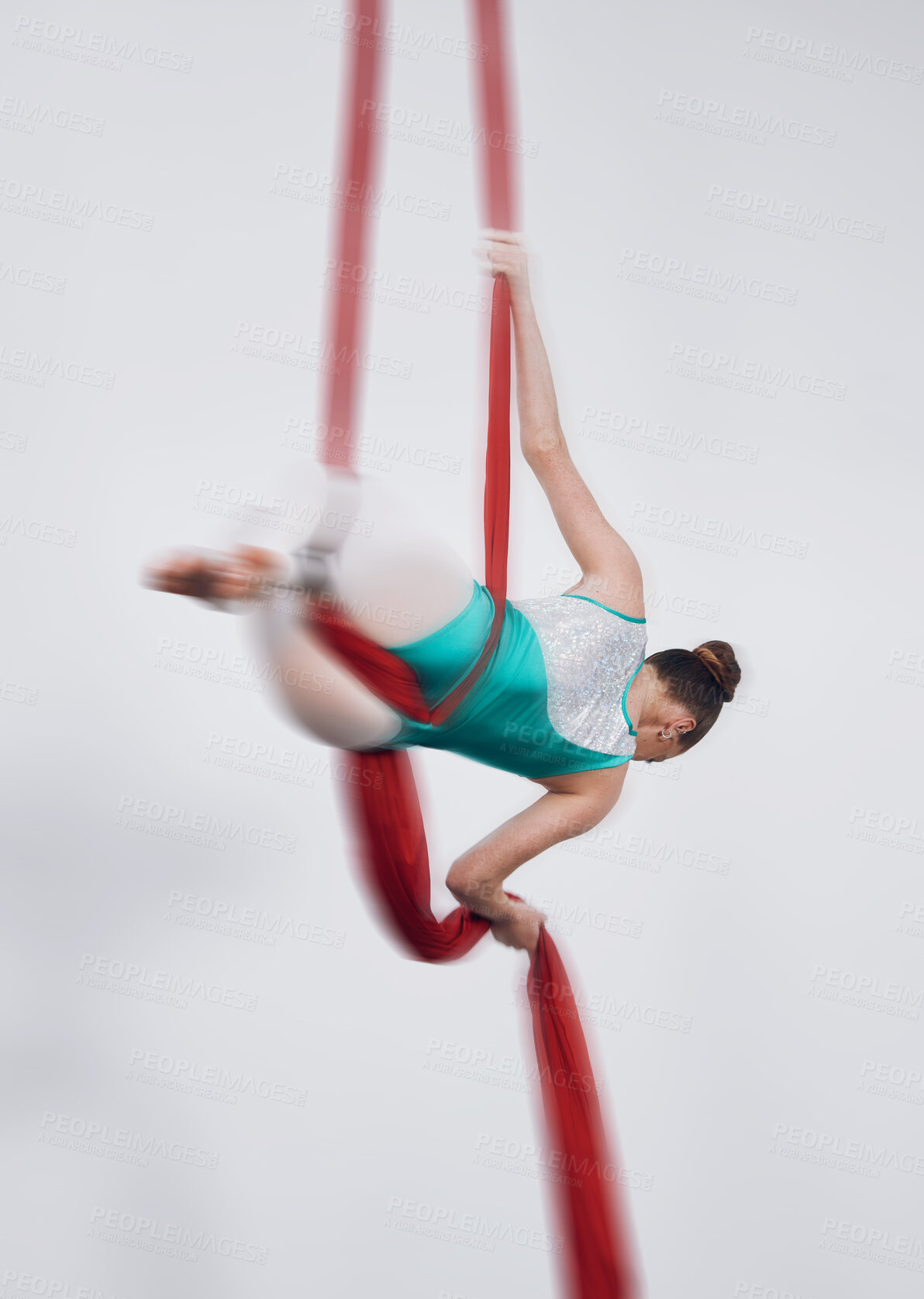 Buy stock photo Aerial silk, acrobat and a woman in air for gymnastics performance, sports and balance. Behind athlete person or gymnast hanging on red fabric and white background with space, art and creativity