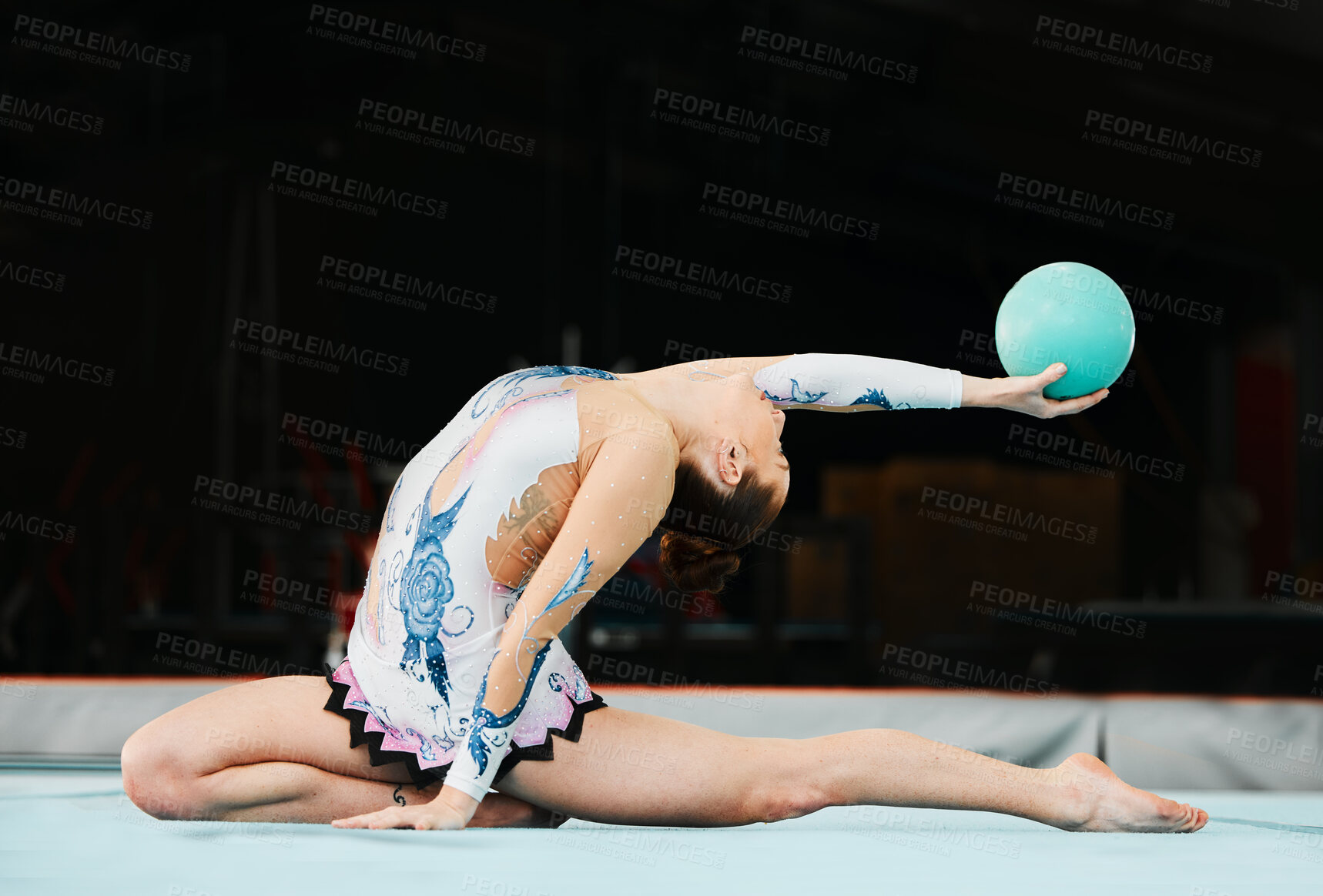 Buy stock photo Woman, ball gymnastics and stretching in competition, performance and showcase solo concert in dark arena. Flexible dancer, rhythm and training with talent, creative skill and agile action in contest