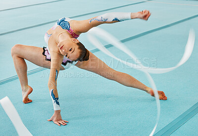 Woman, ribbon gymnastics and dance for performance, sports competition and action show. Dancer, rhythm and creative training of athlete with talent, moving with balance and agile flexibility in arena