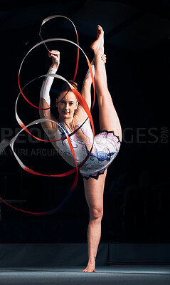 Buy stock photo Woman, portrait and balance for ribbon gymnastics, sports performance or competition in dark concert arena. Flexible athlete, dancer and stretching for agile showcase, challenge and rhythm in contest