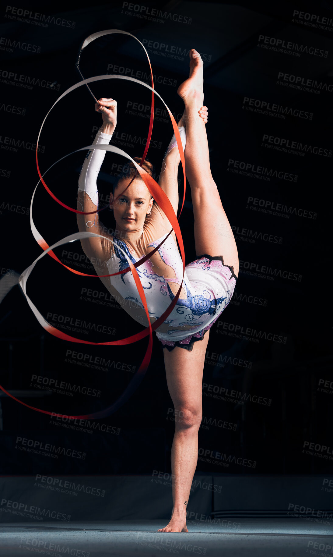 Buy stock photo Woman, portrait and balance for ribbon gymnastics, sports performance or competition in dark concert arena. Flexible athlete, dancer and stretching for agile showcase, challenge and rhythm in contest