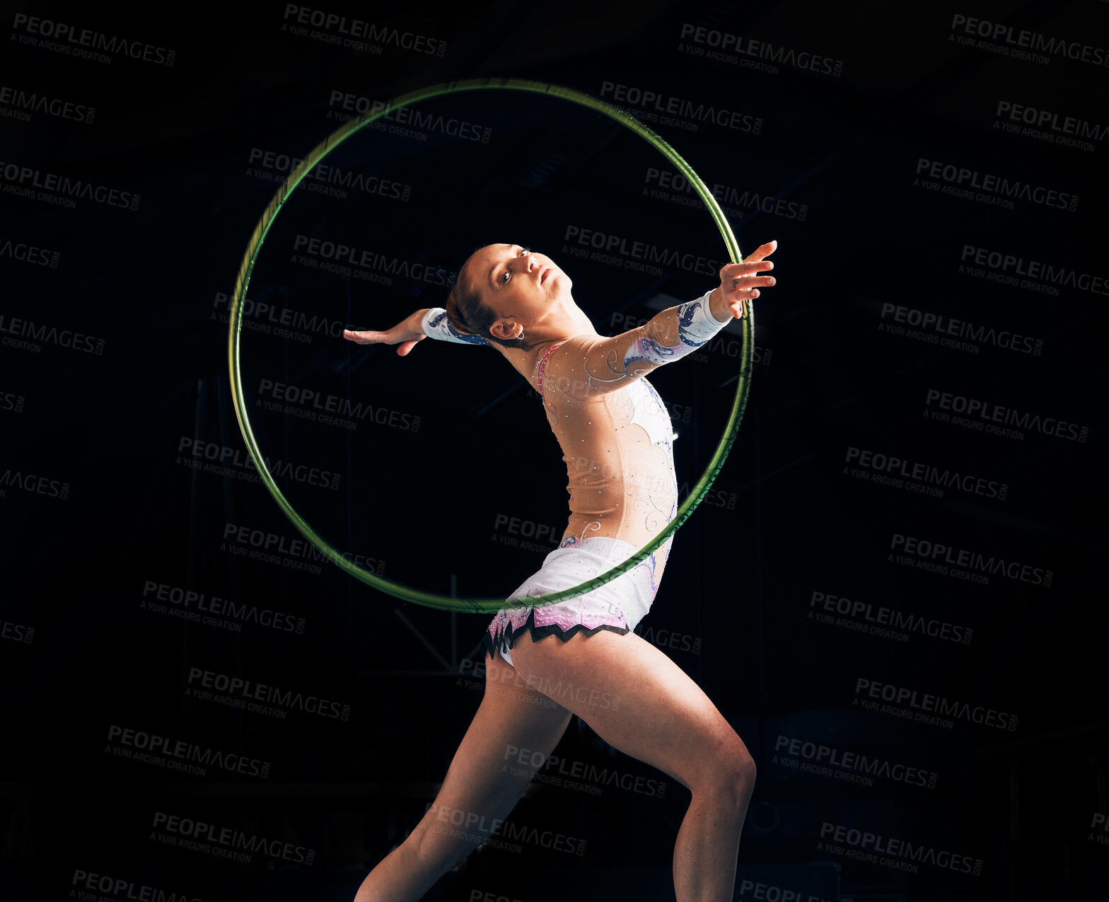 Buy stock photo Dance, training with a gymnastics hoop and a woman in the gym for a performance showcase or practice. Fitness, energy and concert with a female athlete on a dark background for routine or recital