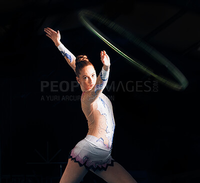 Buy stock photo Fitness, energy with a gymnastics hoop and a woman in the gym for a performance showcase or practice. Dance, training and concert with a female athlete on a dark background for routine or recital