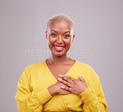 Buy stock photo Gratitude, happy and portrait of a black woman in a studio with sweet, kind and positive attitude. Empathy, grateful and young African female model with thank you gesture isolated by gray background.