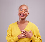 Grateful, smile and portrait of a black woman in a studio with sweet, happy and positive attitude. Empathy, gratitude and young African female model with thank you gesture isolated by gray background