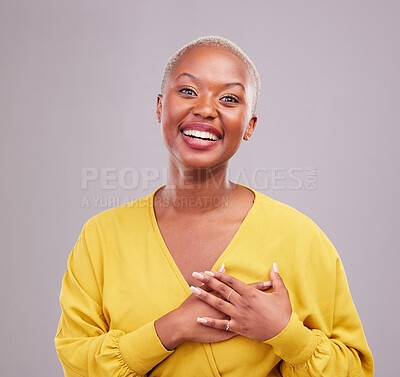 Buy stock photo Grateful, smile and portrait of a black woman in a studio with sweet, happy and positive attitude. Empathy, gratitude and young African female model with thank you gesture isolated by gray background