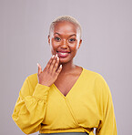 Smile, hand and portrait of a black woman on a studio background for a surprise, gesture or showing. Happy, fashion and an African person or girl with nails for a manicure isolated on a backdrop