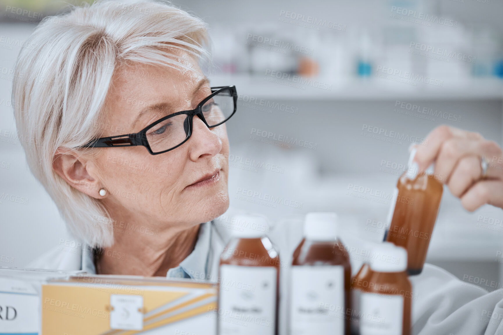 Buy stock photo Senior woman, pharmacist and inventory inspection, medicine or checking stock on shelf at drugstore. Mature female person, medical or healthcare employee reading pharmaceutical product at pharmacy