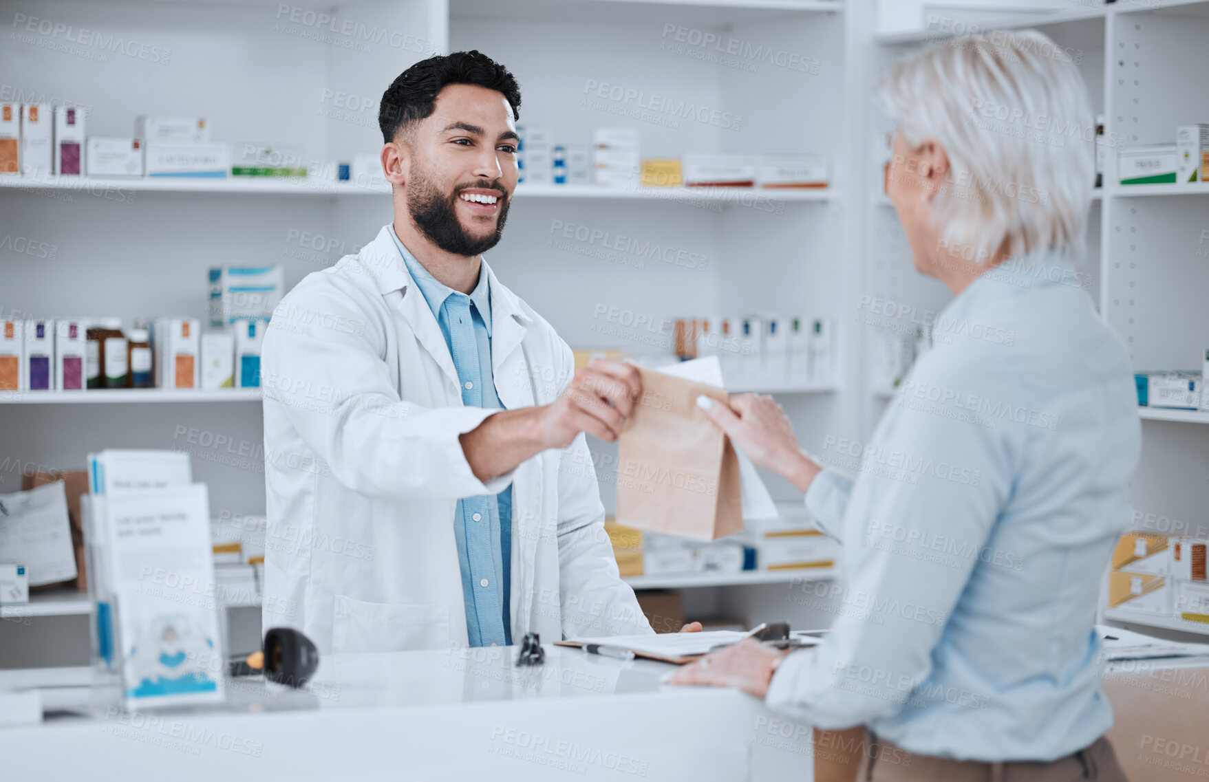 Buy stock photo Happy man, pharmacist and paper bag for customer in consultation, medication or pills at pharmacy. Male person, medical or healthcare employee giving patient pharmaceutical products at drugstore