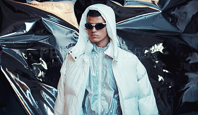 Buy stock photo Holographic, sci fi and man with fashion and futuristic ski style with vaporwave clothing in studio. Art, creative and young male model with trendy, cool sunglasses and cyberpunk designer jacket