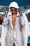 Holographic, vaporwave style and man with fashion and futuristic ski with sci fi clothing in studio. Art, creative and young male model with trendy, cool sunglasses and cyberpunk designer jacket