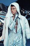 Holographic, vaporwave jumpsuit and man with fashion and futuristic ski style with sci fi clothing in studio. Art, creative and young male model with trendy, cool sunglasses and cyberpunk jacket