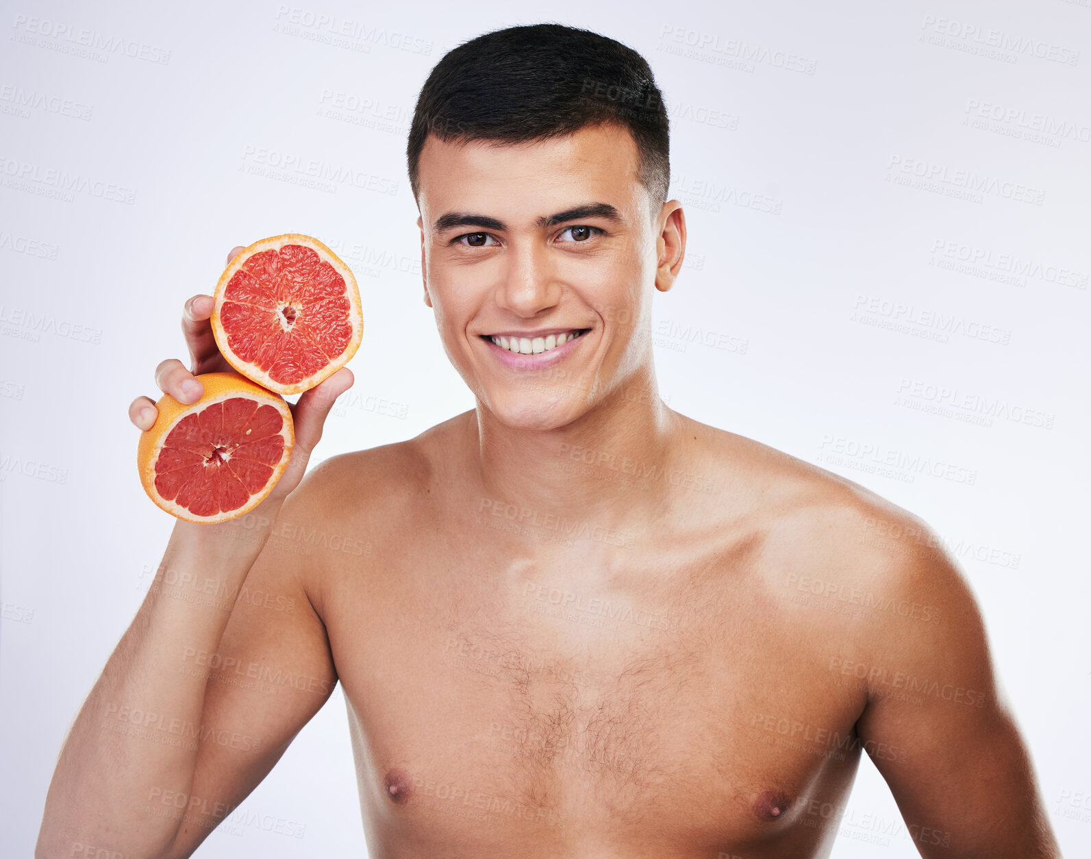 Buy stock photo Skincare, grapefruit and smile with portrait of man in studio for beauty, detox and natural cosmetics. Vitamin c, nutrition and spa with person and fruit on white background for self care and glow 
