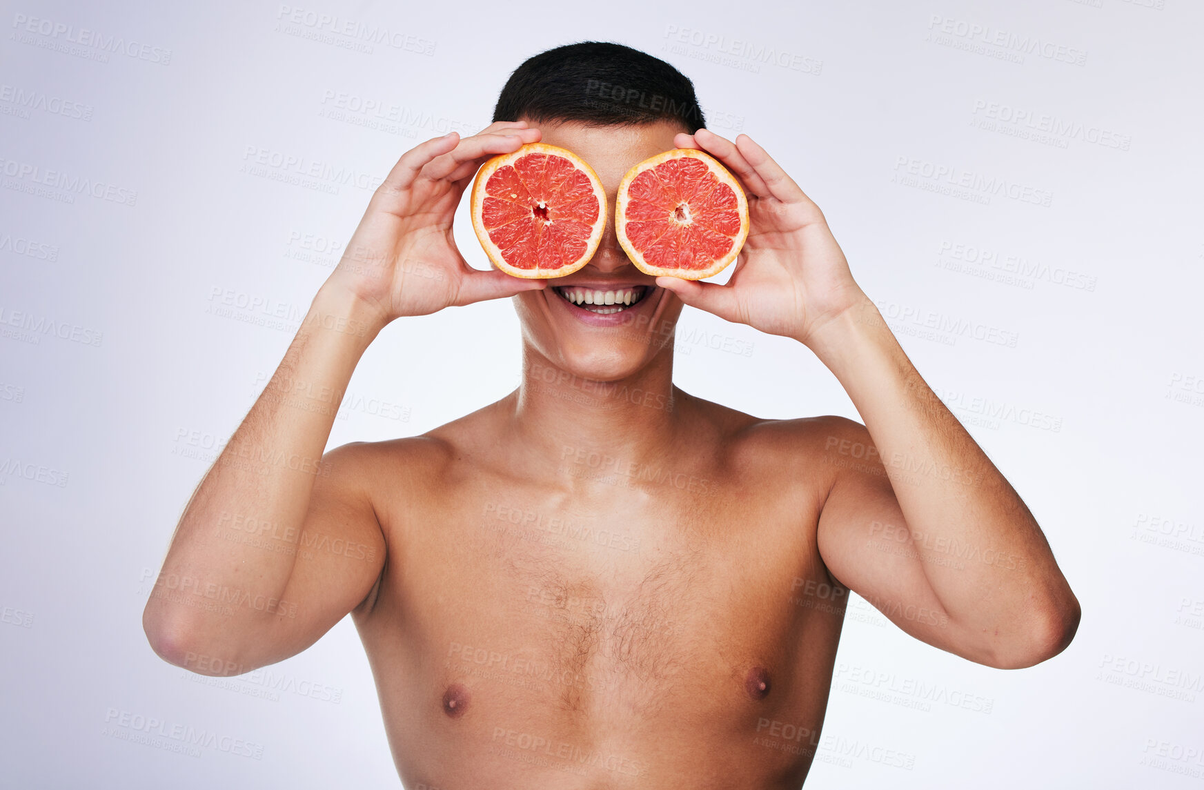 Buy stock photo Beauty, grapefruit and skincare with face of man in studio for health, detox and natural cosmetics. Vitamin c, nutrition and summer with person and fruit on white background for self care and glow 